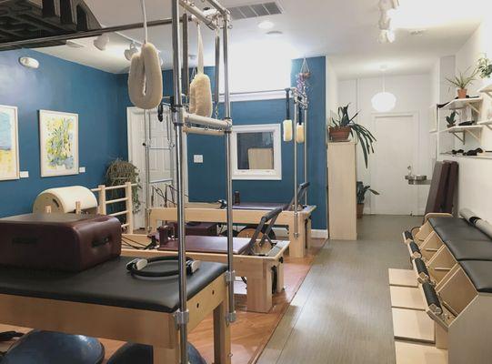 Fully-equipped studio space includes reformers, chairs, and cadillacs,