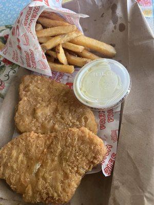 Chicken "strips" and a fries with half full cup of ranch.