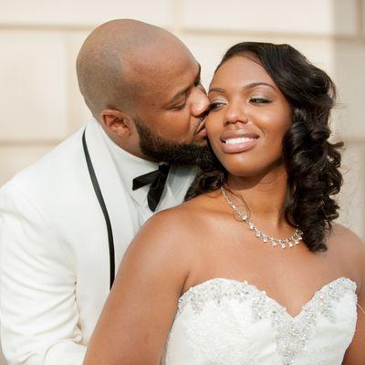 Groom stealing a kiss from his bride. We have helped thousands of couples tie the knot.