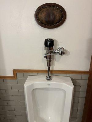 The epitome of American male sophistication! A urinal headrest. Two thumbs up!!