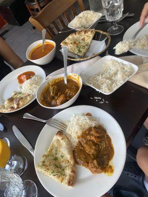 Garlic nann bread, rice, lower left goat curry and upper left is chicken Chicken Tikka Masala