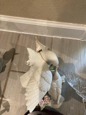 Broken wing on ceramic bird