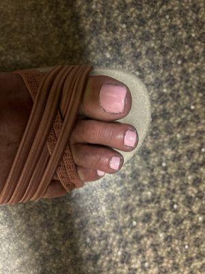 Uneven trim work, polish outside of nail area, cuticles look terrible.