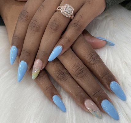 Beautiful almond shape gel nail enhancements with blue and marble design. Perfect for spring.