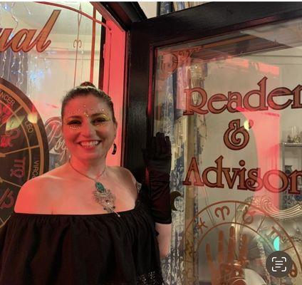 Shannon in the door of her psychic shop.