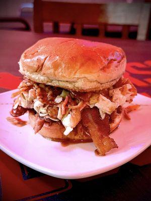 Ultimate Pulled Pork. House Made Pork, Thick cut Bacon, Captain Morgan Sauce, Slaw, and Crispy Onions