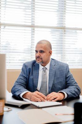 Image of Stephen Palermo sitting at his desk in Visalia Gold Standard Mortgage office