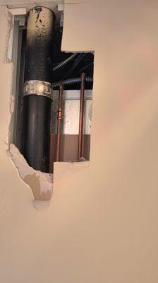 Hole in wall to fix the burst pipe
