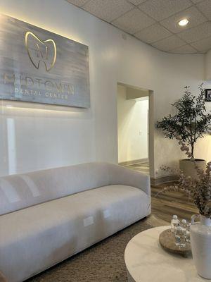 Plush seating and neutral aesthetics, this is the area straight ahead, when you do walk into the office.