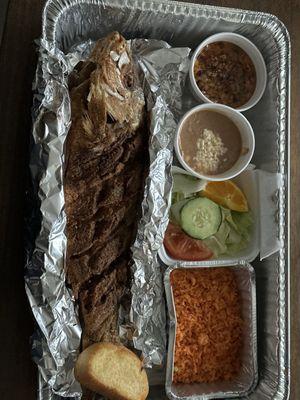 Red snapper with garlic, butter, rice, and beans