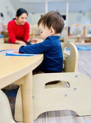 Child sitting in a chair at a table