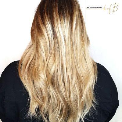 A combination of techniques using foils and open air balayage with a root shadow and gloss