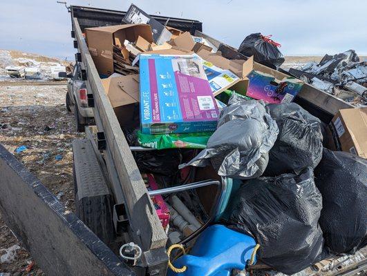 At the dump disposing of trash and junk collected.