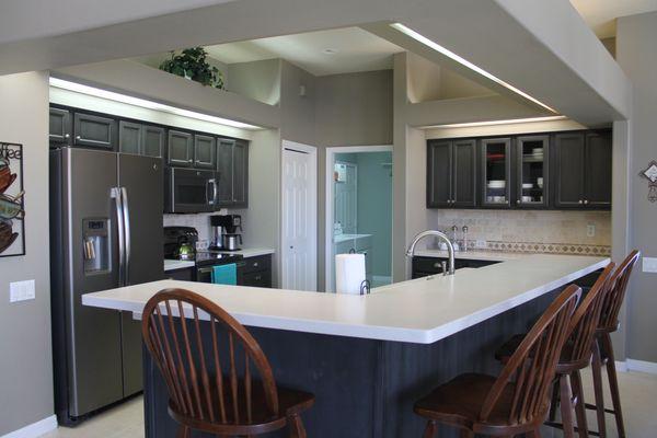 Espresso Cabinets, White coutnertops.