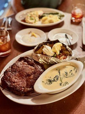16 oz ribeye with creamed spinach and fully loaded backed potato. Plenty for two!