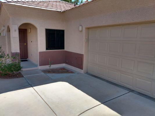 Painted house garage door and trim section.