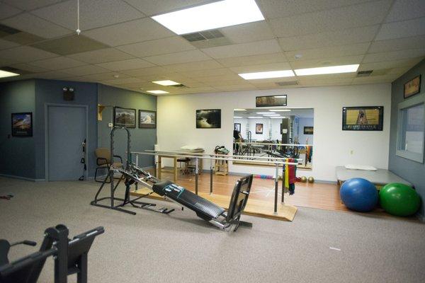 The inside of the Little Egg Harbor office has parallel bars and a large open space for treatment.