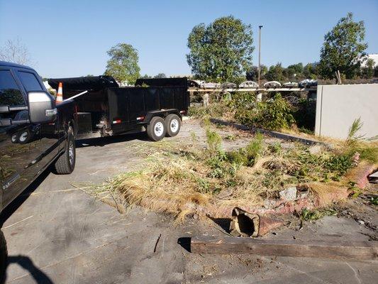 Parking lot demolition of spaces and trash can enclosure.