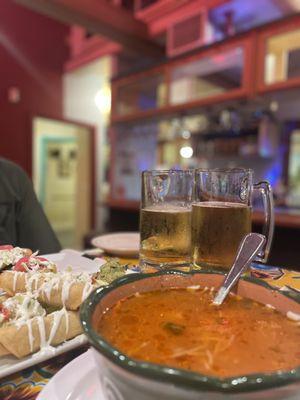 Tall glass beers, chicken Taquito and fideo