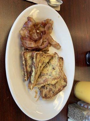 Full raisin French toast with a side of floppy bacon.