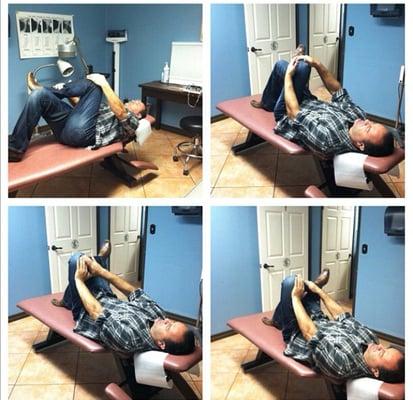 OUR CHIROPRACTOR TEACHING US PROPER LOWER BACK STRETCHES.