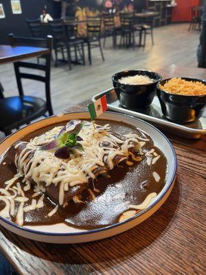 Sides of refied black beans top with refried black beans w Parmesan and rice