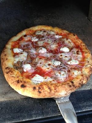 Sausage, mozzarella, goat cheese, and shaved red onion.
