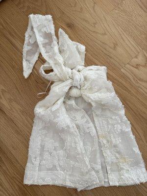 A tangled mess and has yellow spots all over the garment. It was not like this when I dropped it off.