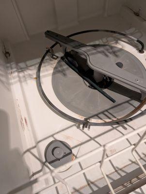 used knife and straw left in dishwasher with a rusted heater coil and molded walls.