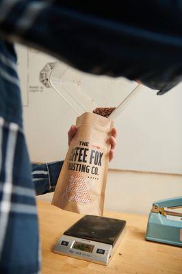 Weighing out retail bags of coffee