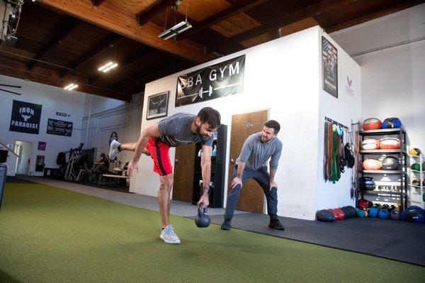 Working balance while coach pays close attention to all the details