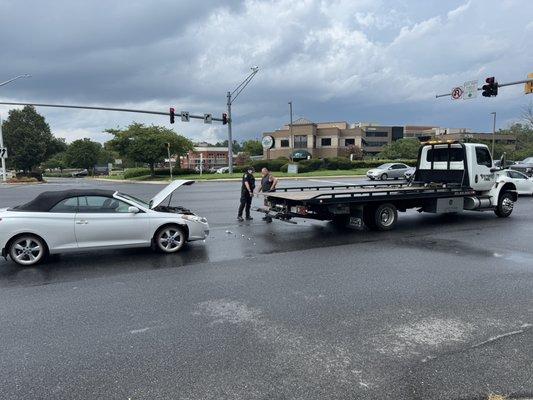 Toyota Solara being prepped to be towed by Stronghold Towing.