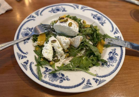 Fresh buffalo mozzarella on top of a bed of arugula & fennel in a citrus vinaigrette topped w/ pistachios & orange segments