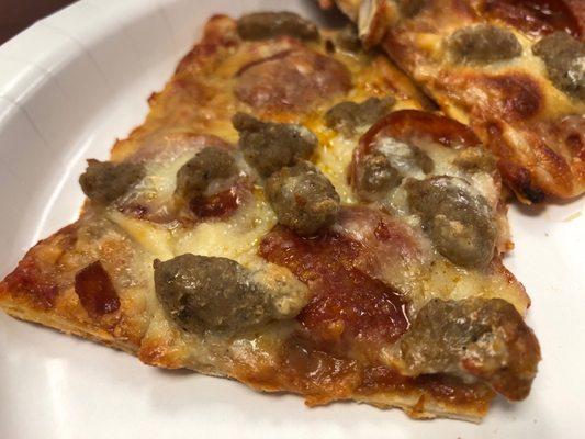 A couple of pepperoni & sausage slices