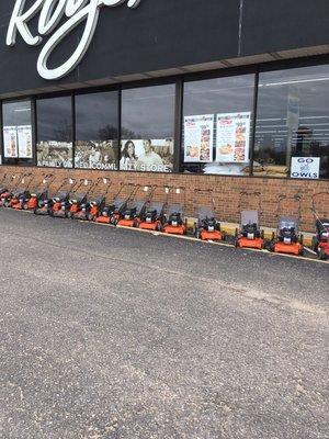 Push mower selection with Husqvarna riding lawnmowers parked on display next to US23
