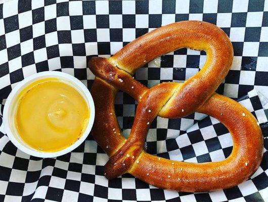 This jumbo pretzel with cheese pairs perfectly with one of the local beers!