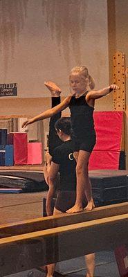Balancing on the beam and help with beam handstands.
