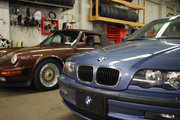 This modern BMW 3 series proudly shows off her periwinkle blue paint next to her more mature cousin, a Porsche 911 Cabriolet.