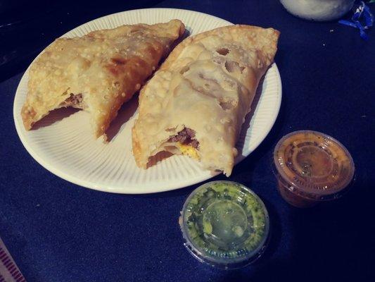 Beef and chicken empanadas. Fresh out of the fryer. So good!!! Red sauce has some kick green is flavorful and pretty mild.