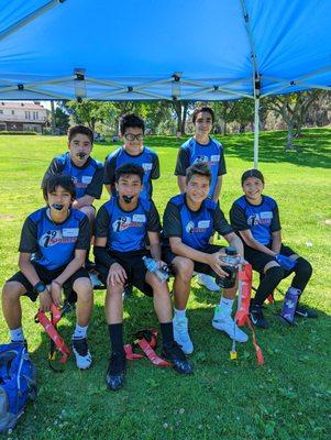 Quick break under the shade for these flag football players.
