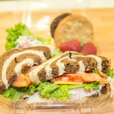 Russian Turkey Club on Marble Rye with Cookies, Potato Salad, and Fresh Strawberries.