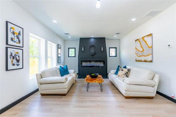 Newly renovated living room with black fireplace