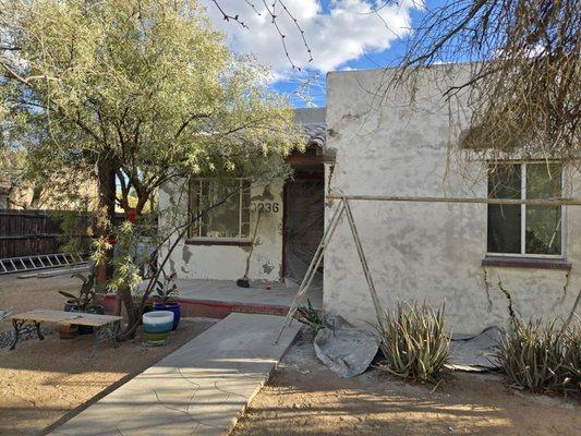 Front of house after stucco removed