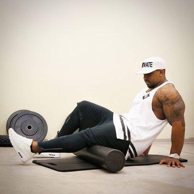 Coach D.J. doing a little foam rolling before a workout