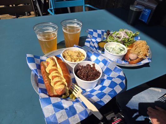 Bierwurst w/mustard in a bun with potato salad & red cabbage (L). Brat w/sauerkraut in a bun with a side salad & German cucumber salad (R)