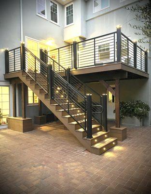 Trex Transcend decking in Jasper and Trex Signature Rod railing with LED stair riser lights and post cap lights