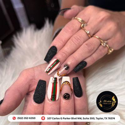 Matte black nails paired with white accents, jeweled chains, and luxury-inspired details. This set screams elegance with an edgy twist.