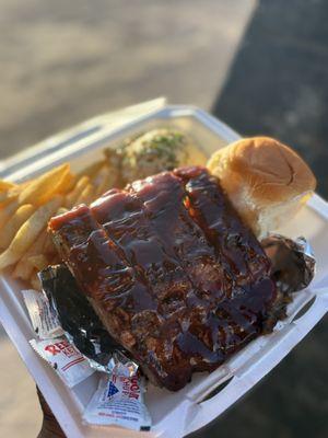 Pecan smoked BBQ baby backs ribs with golden crispy fries, and homemade Louisiana style potato salad.