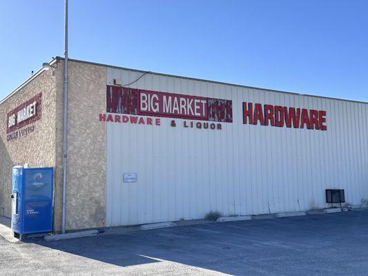 Sign on side of building for hardware and liquor.