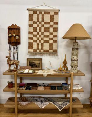 Curated display of handcrafted leather goods, vintage decor, and warm textures reflecting Ember & Stitch's Western-inspired aesthetic.